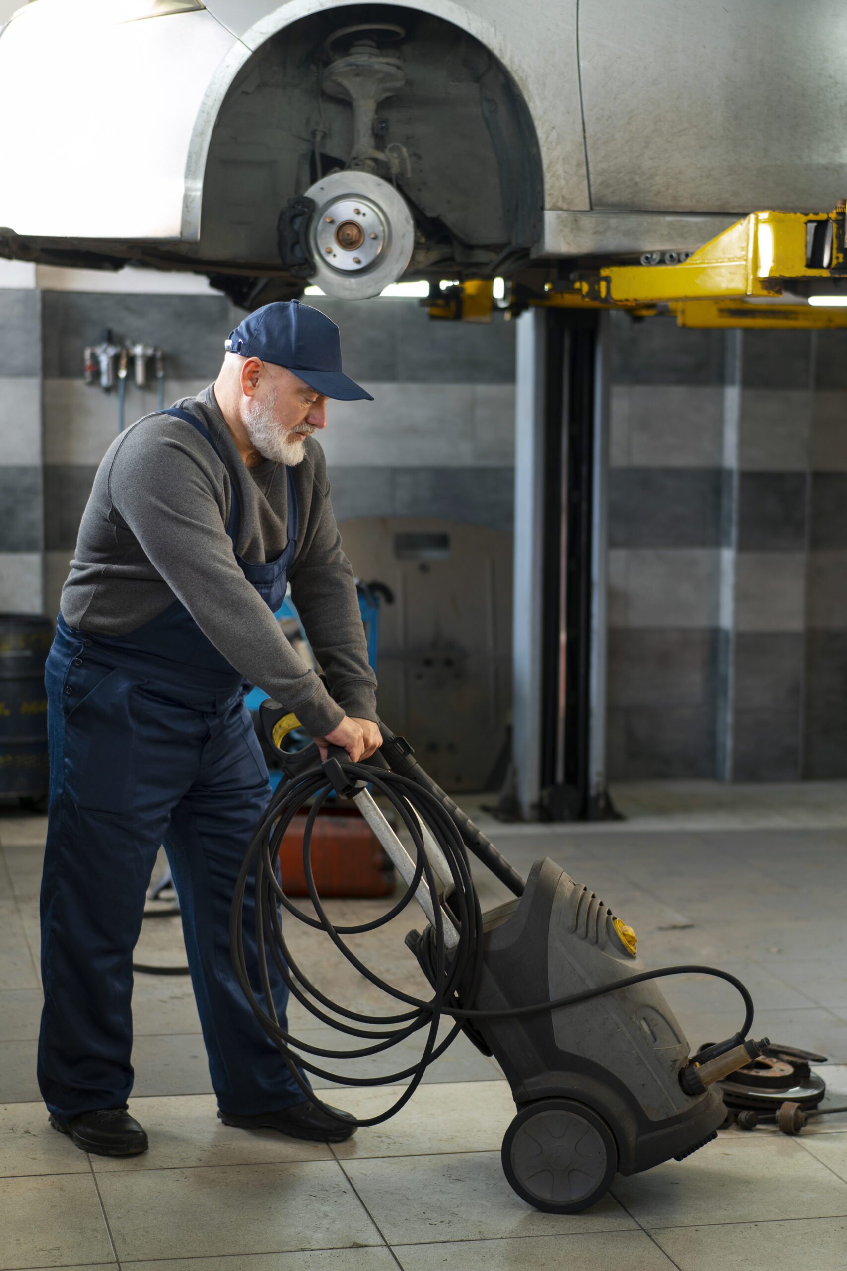 male-car-mechanic-working-car-repair-shop