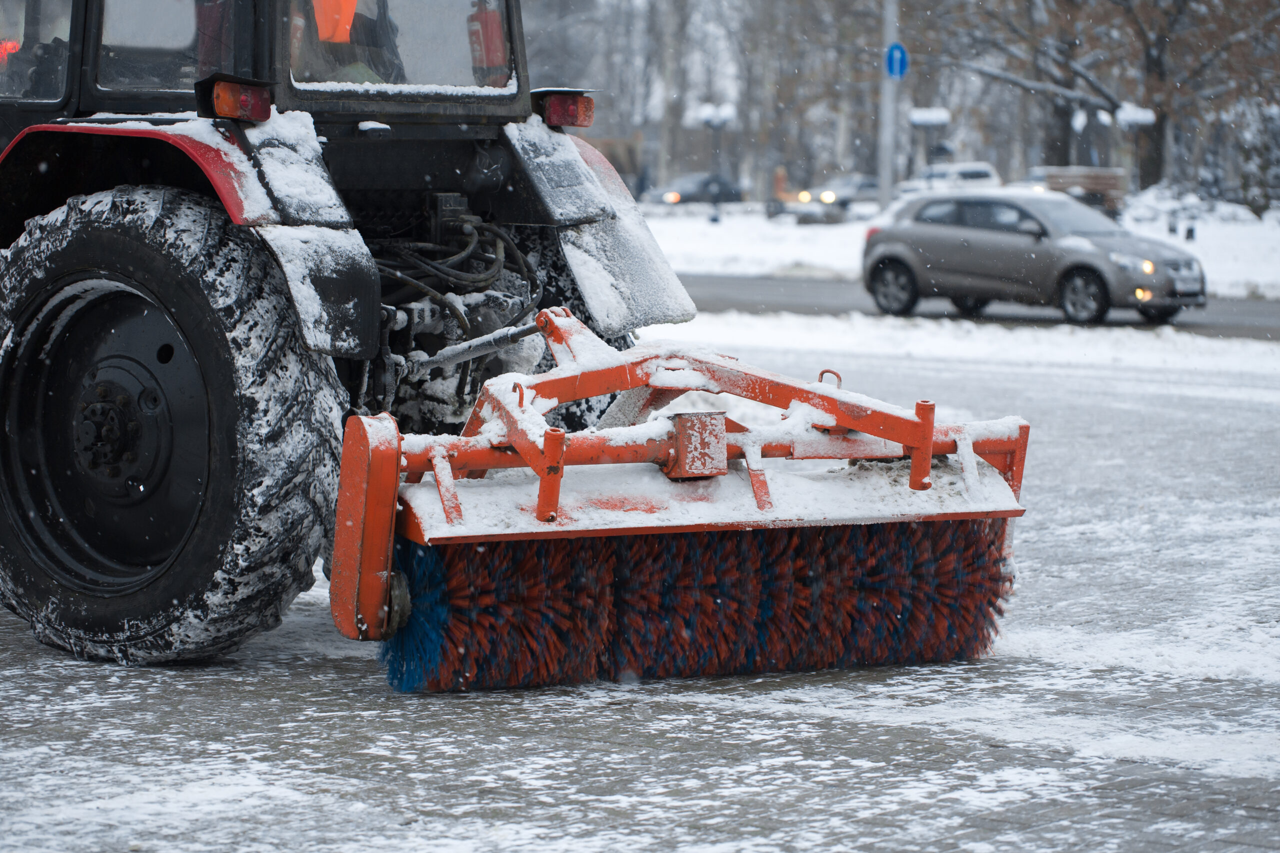 Tractor cleans snow brush